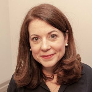 A white woman smiling in a headshot.