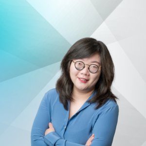 Annie Chen is smiling in a professional headshot with a blue long sleeve blouse.