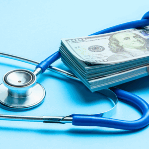 Stack of cash dollars and stethoscope on blue background. The concept of medical doctors salary