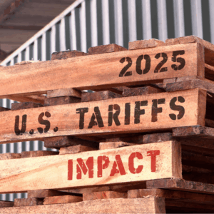 2025 U.S Tariffs impact, text written on piled up pallets