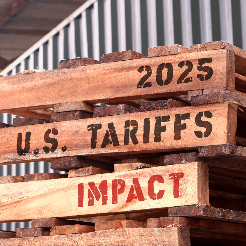 2025 U.S Tariffs impact, text written on piled up pallets