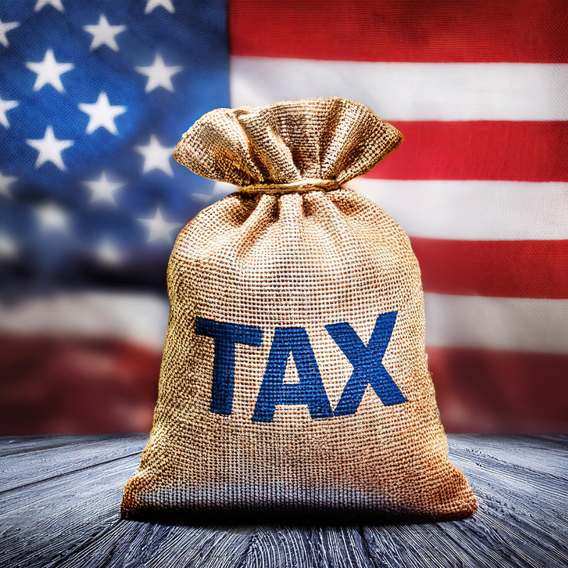 A big burlap sack with Tax written in blue capital letters in front of an American Flag representing the The One, Big, Beautiful Tax Bill.